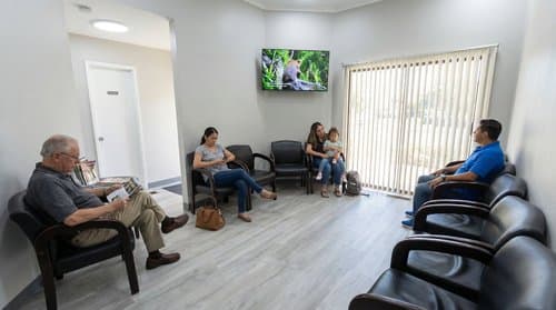 Patients in the bright waiting area at Stockton Comfort Dental